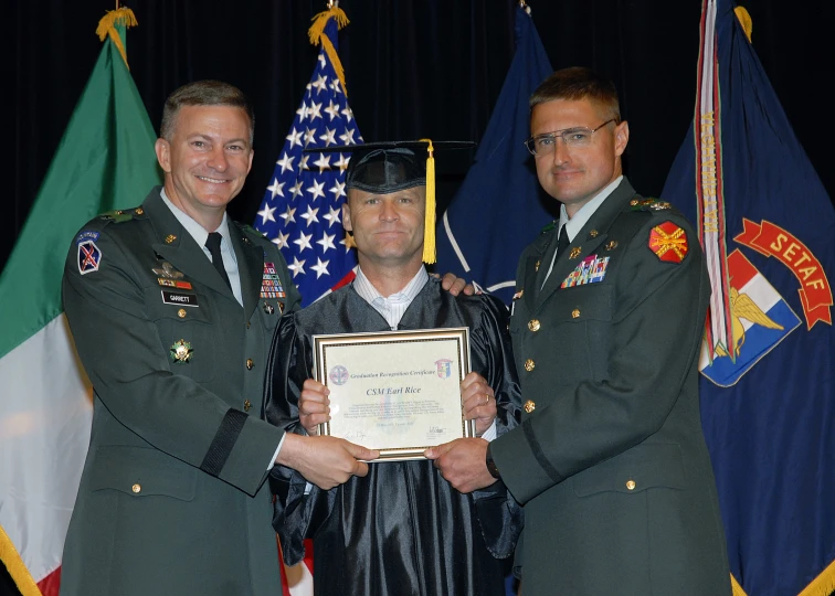 two men in military uniforms with their awards in front of flags