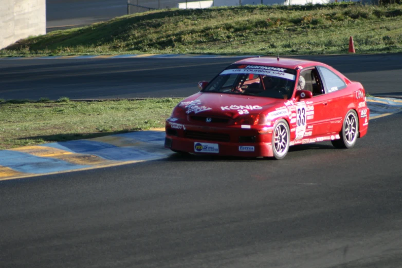 a car with a number on it is on a race track