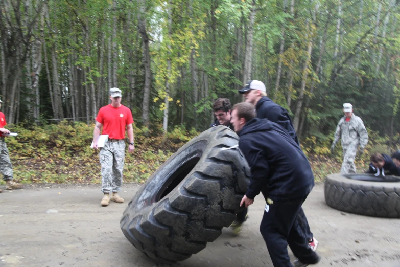 two people trying to fit their tires on the ground