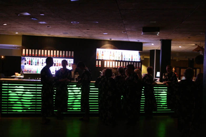 group of people at bar in dimly lit building