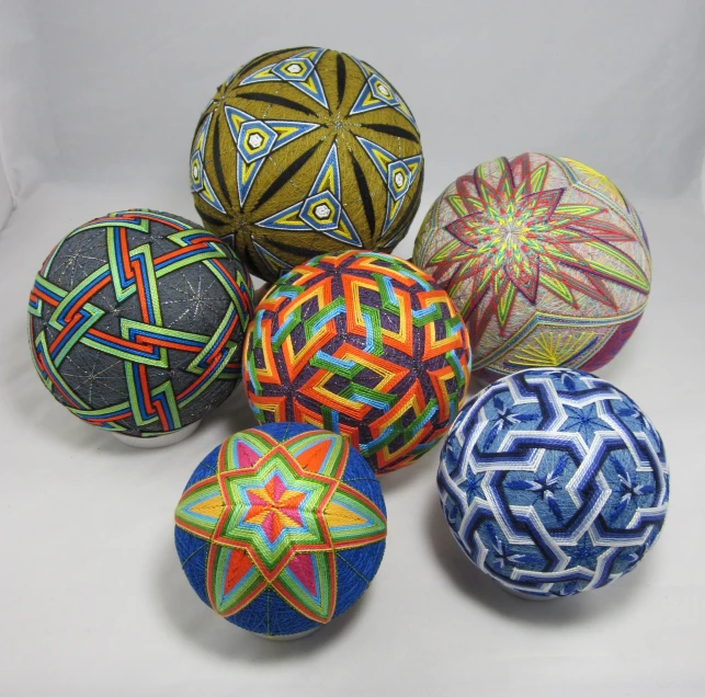five balls made from african fabric on a white table
