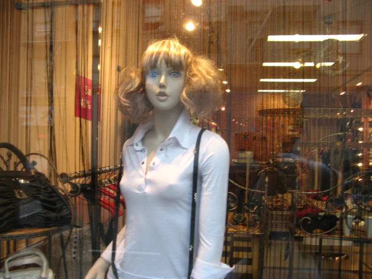 a female mannequin is holding a purse