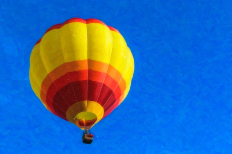 a large yellow and red balloon in the sky