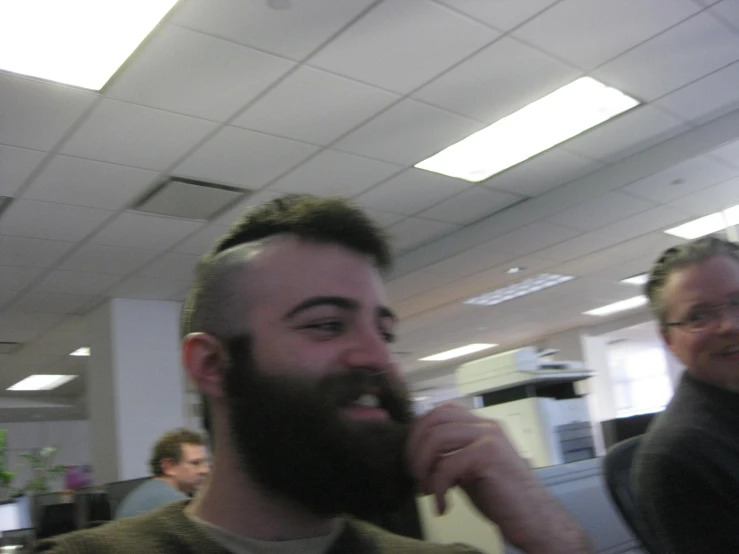 a man has a beard and looks to his right