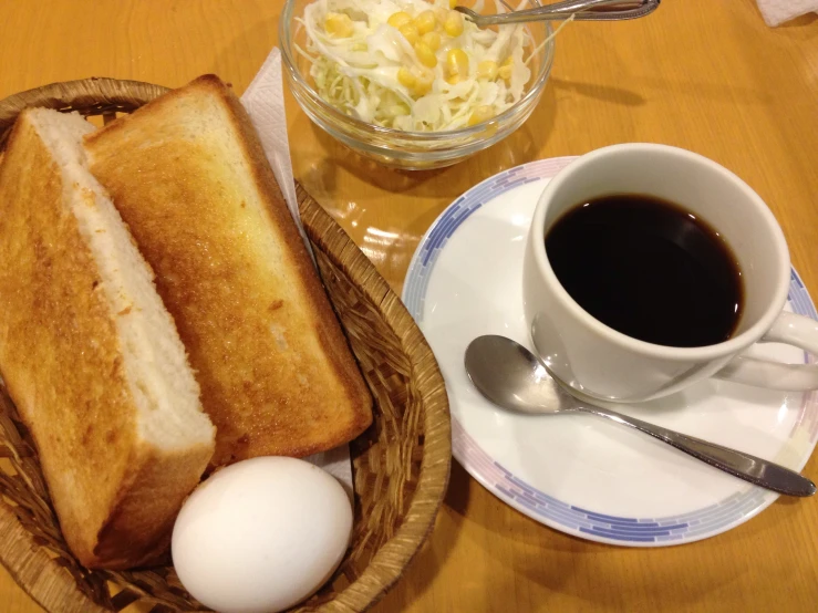 this table has some bread and a coffee mug