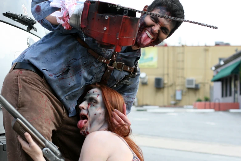 two people with zombie makeup holding a man on their shoulder