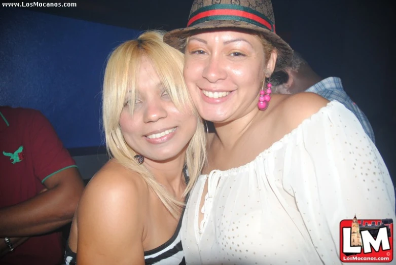two beautiful blonde women posing for a po
