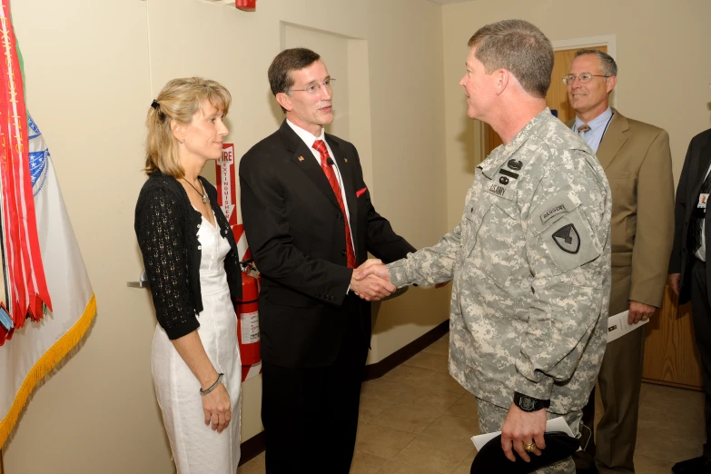 military officers shaking hands with each other in a room
