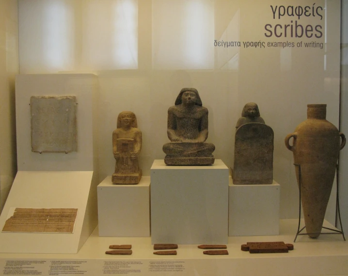 several vases on pedestals in an ancient museum display