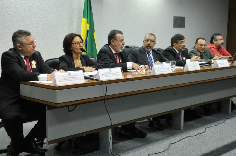 a group of people sitting in front of a table