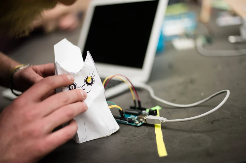 an image of someone decorating an object with electronics