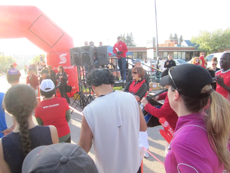 a band playing on a street at the beginning of a race