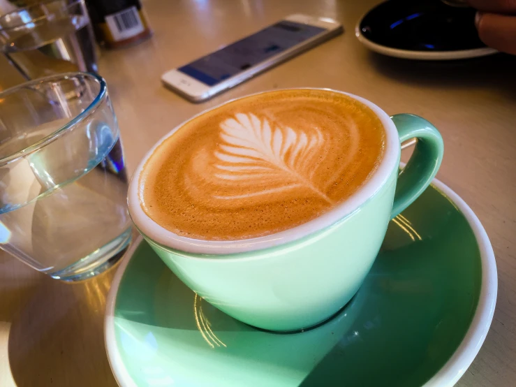 a cup of latte with an unusual pattern