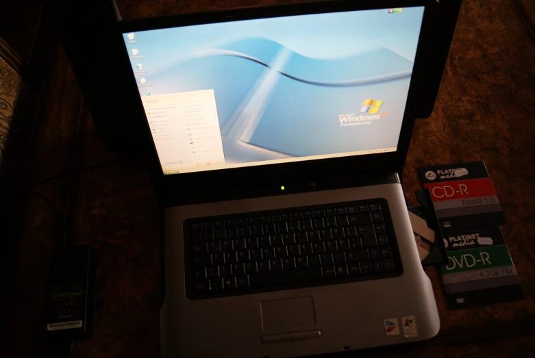 a laptop with a lit screen on a desk