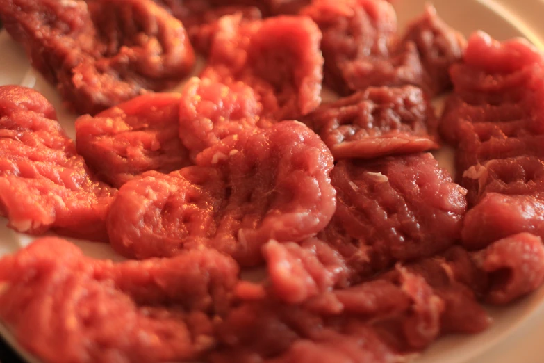 the pieces of meat are piled up on a plate