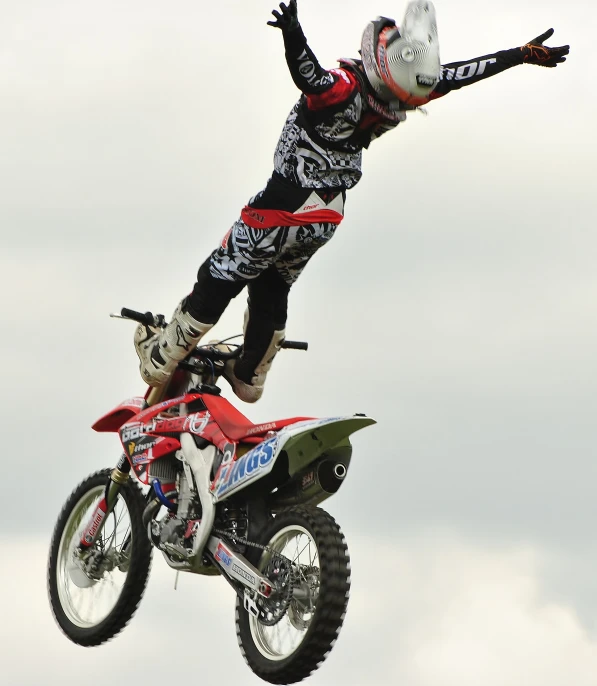 a man riding on the back of a dirt bike in the air