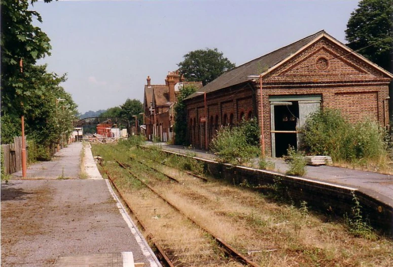 an abandoned train station and its track