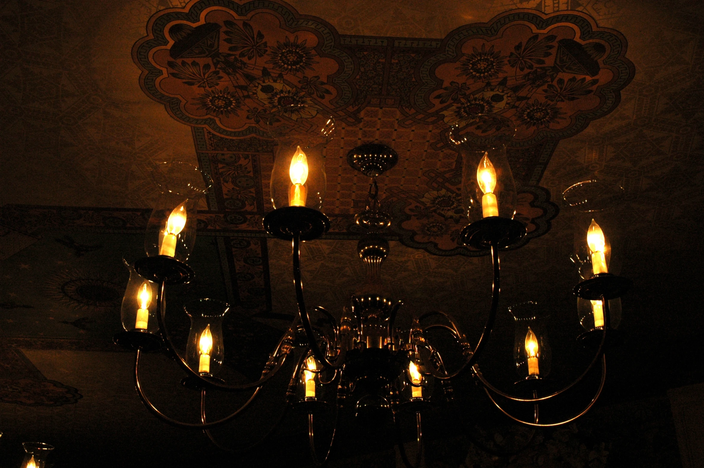 a chandelier has lit candles in it