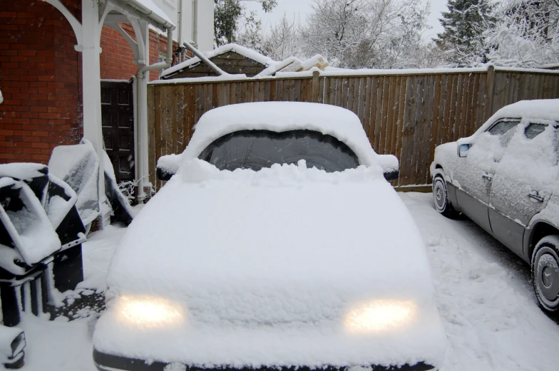 two cars with a light covered in snow