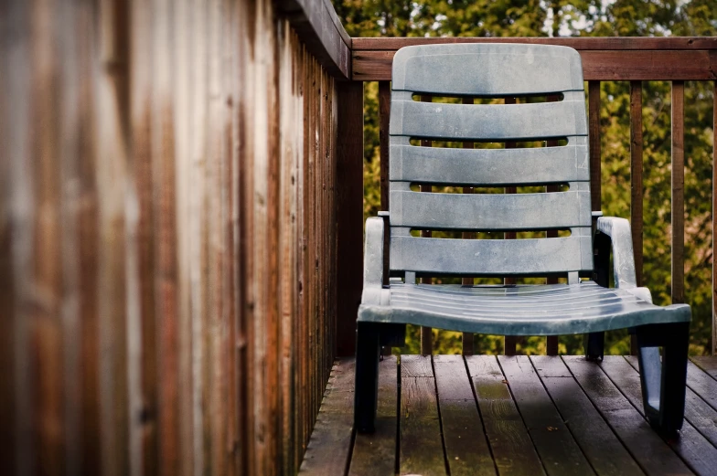 a chair on a deck is shown in this image