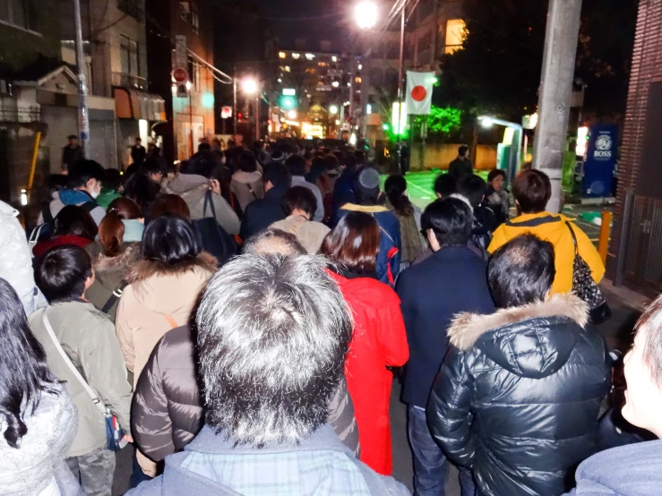 a crowd of people that are walking down the street