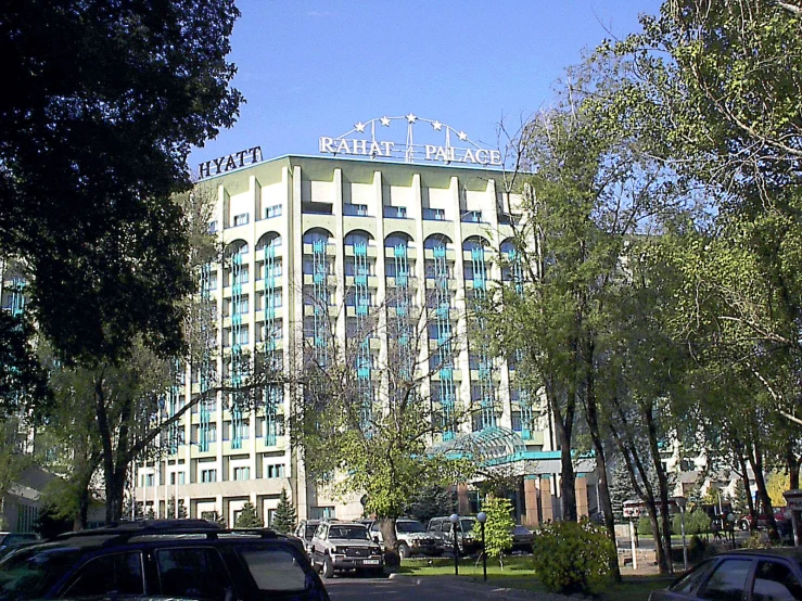 an apartment building and car parks in a city area