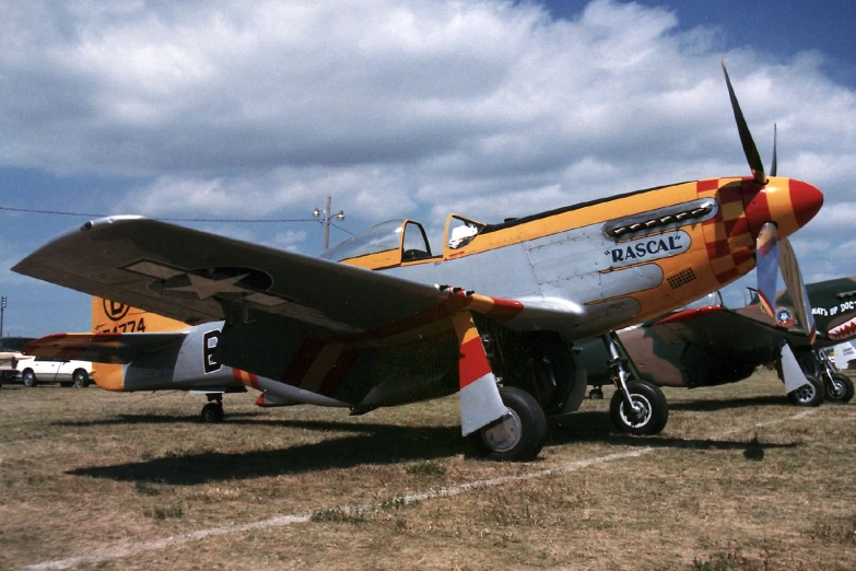 a small orange and gray plane with some propellers