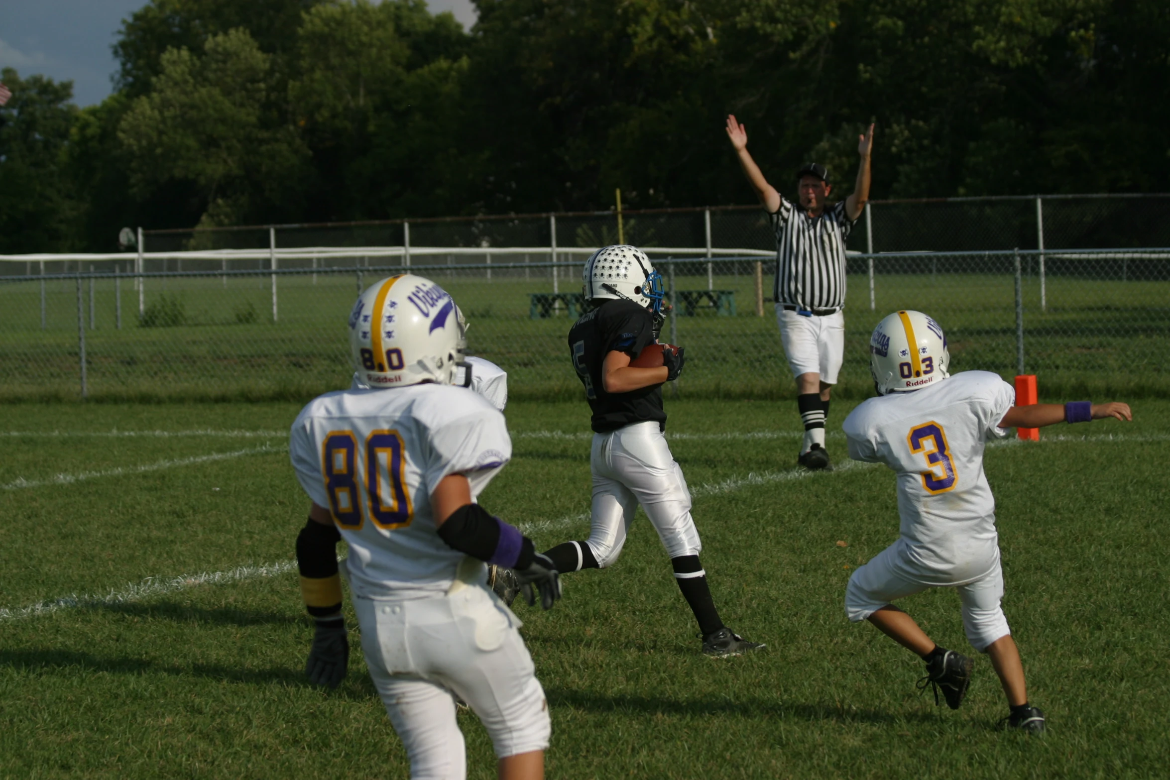 a bunch of s are playing football in the field