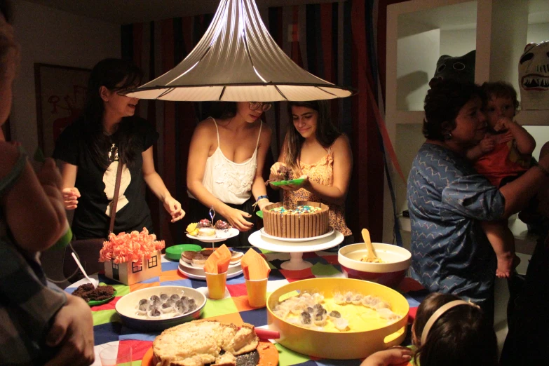 the women are looking at the cake that has been cut