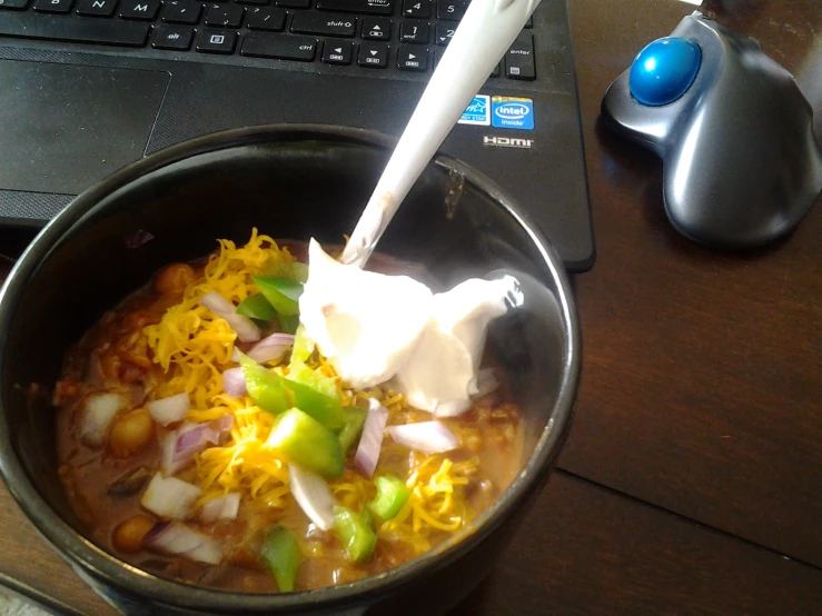 a metal pan filled with rice and beans and vegetables