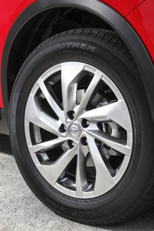 a close up s of the wheels on a red car