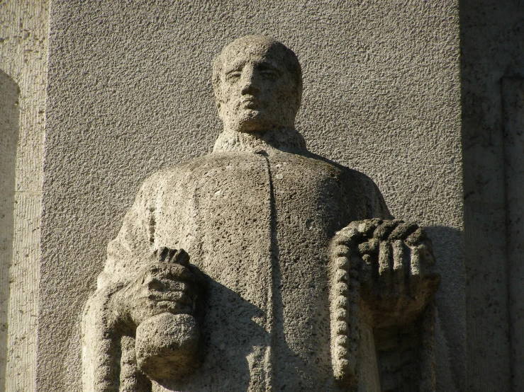 a statue of a man holding an object in his hands