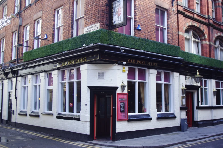 the outside of a building with windows and plants growing on top of it