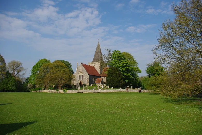 a church sits among the trees and grass