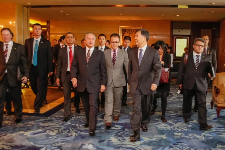 people in suits and ties walking up the steps of a el