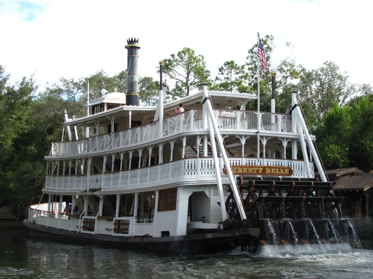 a large white boat with multiple levels in water