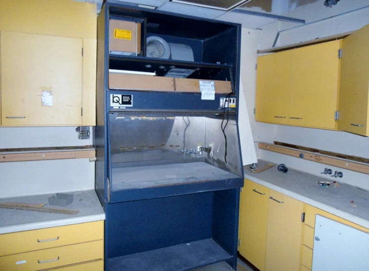 yellow and black kitchen cabinets with electrical components in them