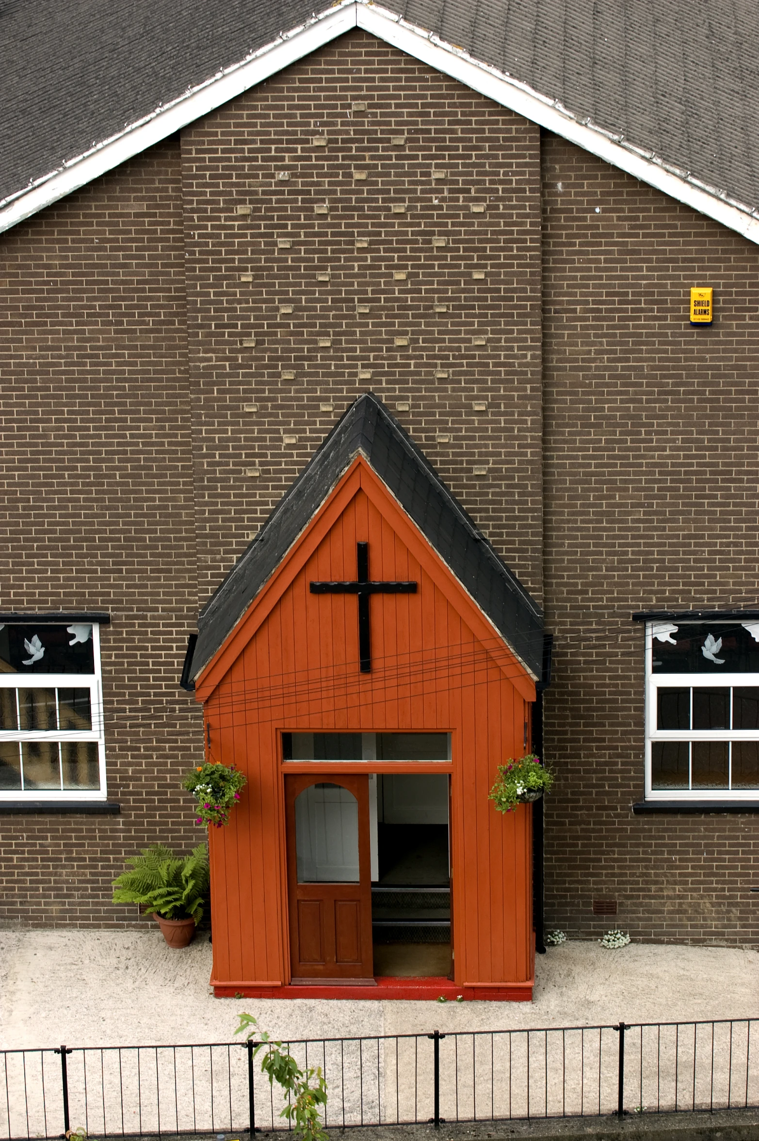 a small wooden church with three windows