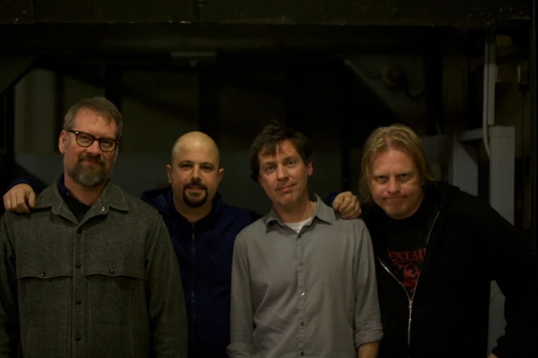 five men and a boy are posing together