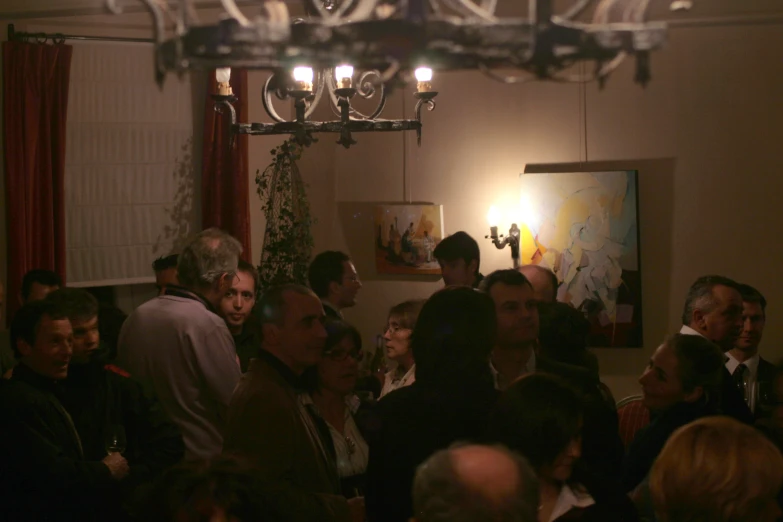 a crowd of people sitting around and standing together