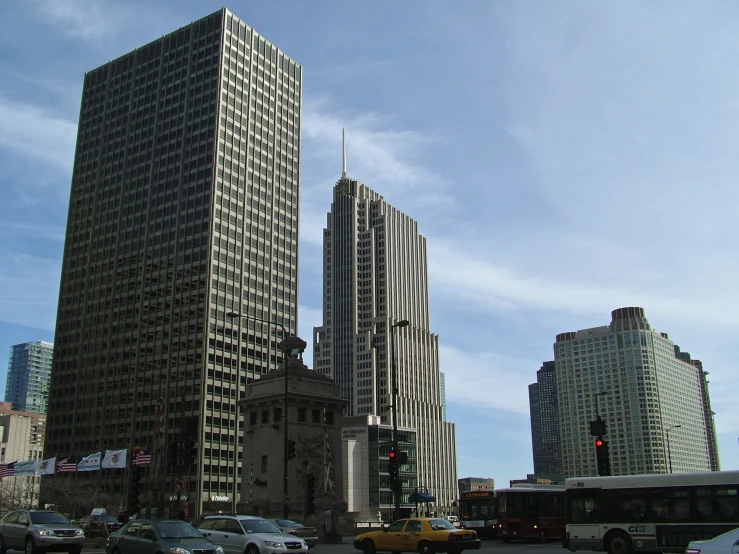 large buildings standing on top of a street with lots of traffic