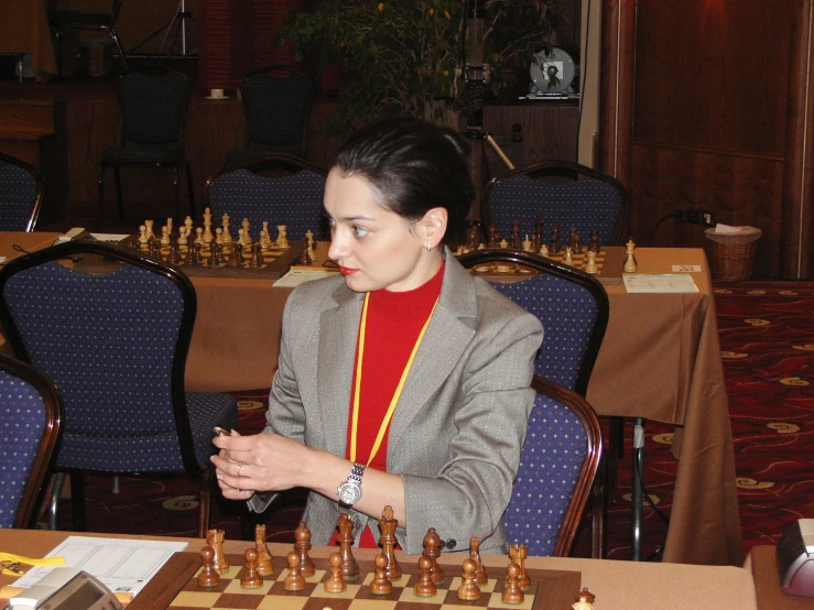 a lady is playing a game of chess