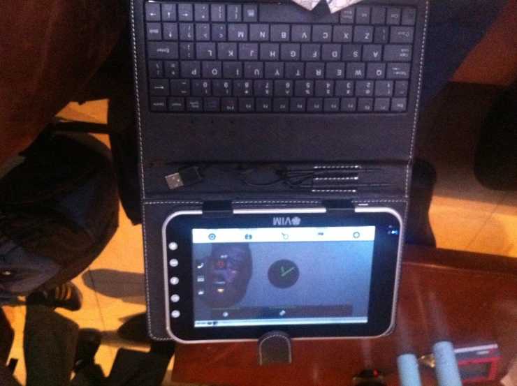 an open laptop sitting on top of a wooden table