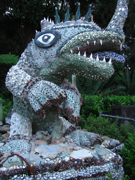 a dragon statue made out of beer bottle caps