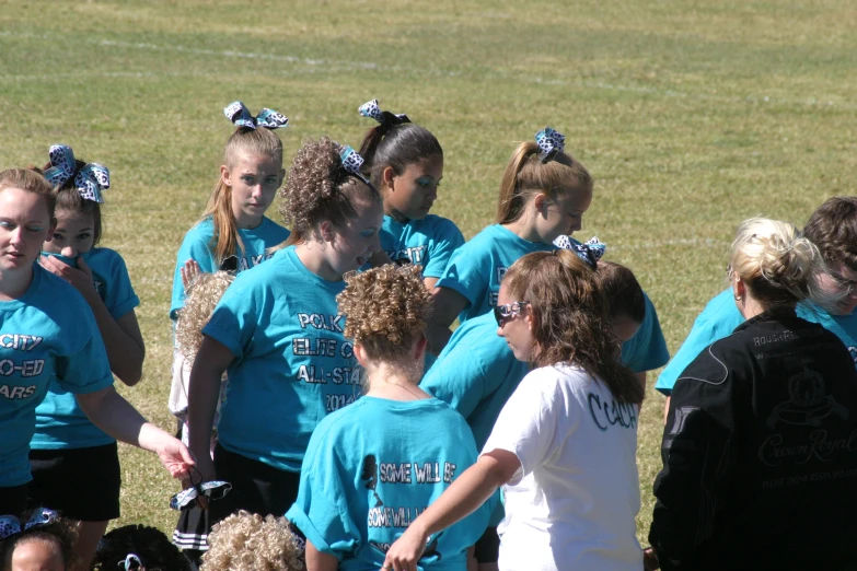 a group of people in a field next to each other