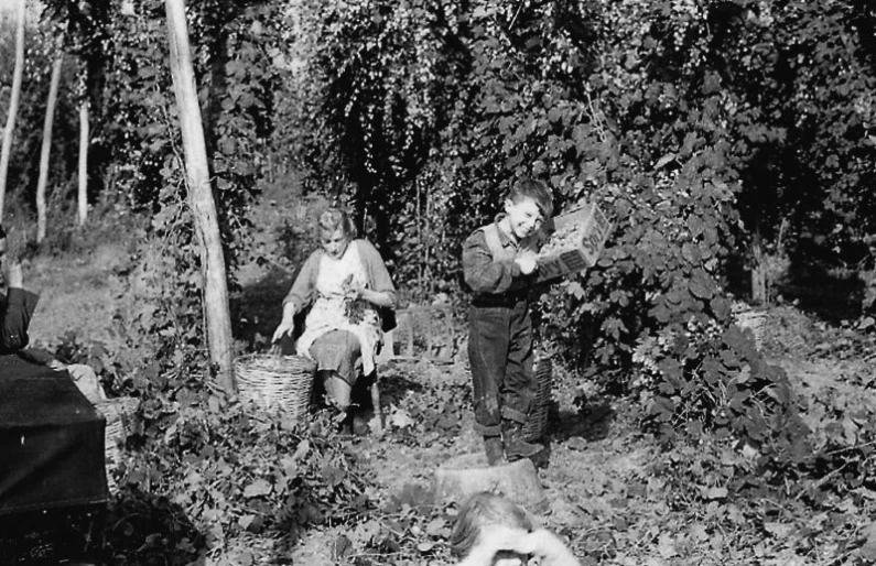 several people, including children, are sitting on the ground