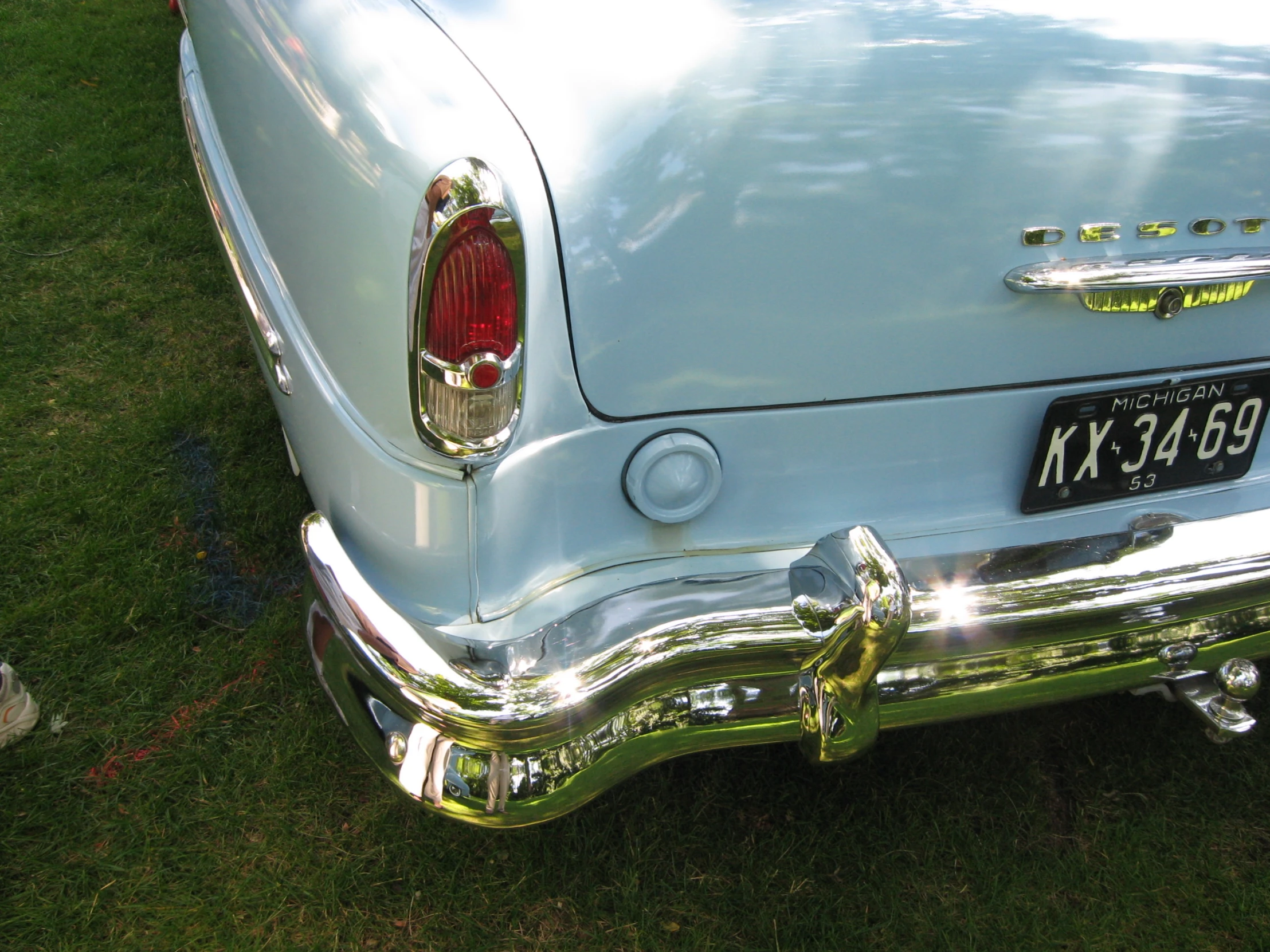 this old car is parked on the grass