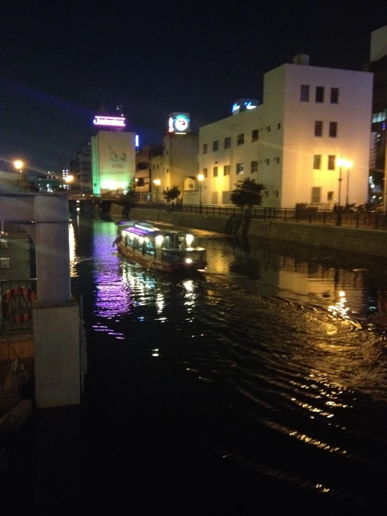 boats on the water at night in the city