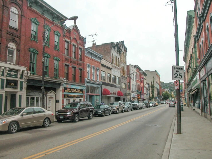 several cars parked on the side of an empty street