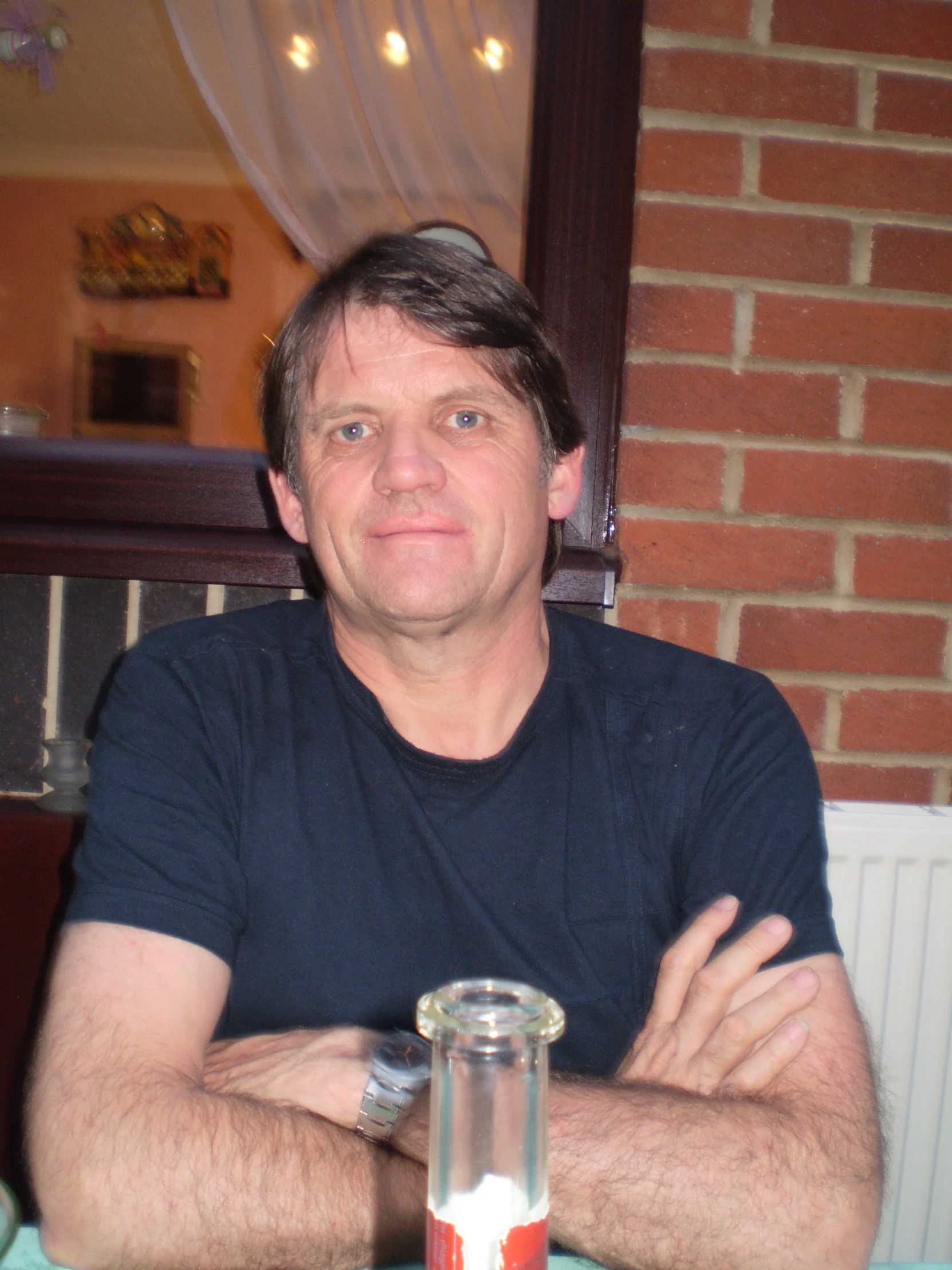 man with a beer bottle on a table at a restaurant